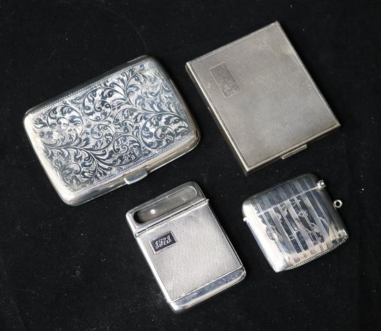 A silver cigarette case, a compact, a vesta and a match case.